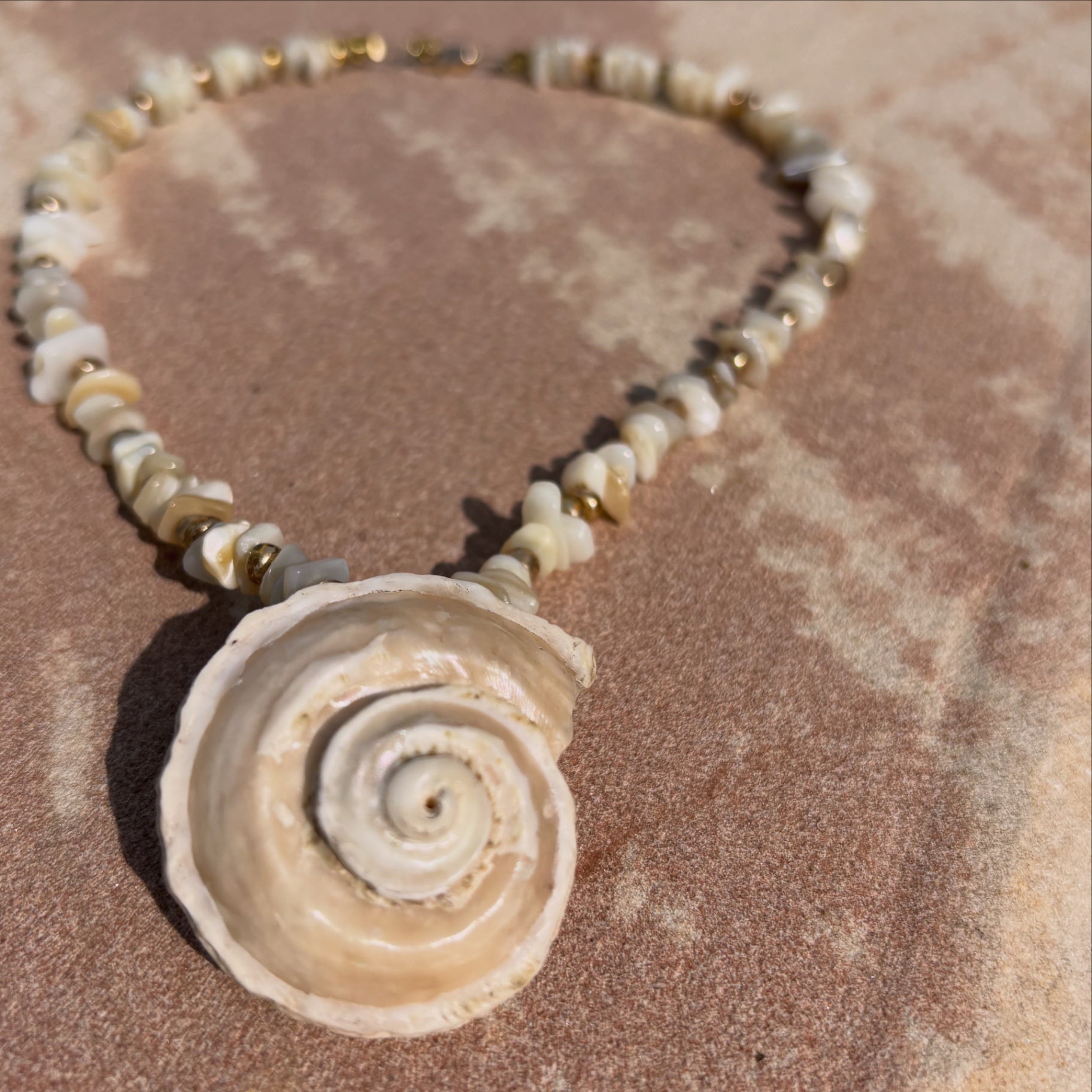 Sea Whisperer necklace — ivory shell beads with spiral shell pendant
